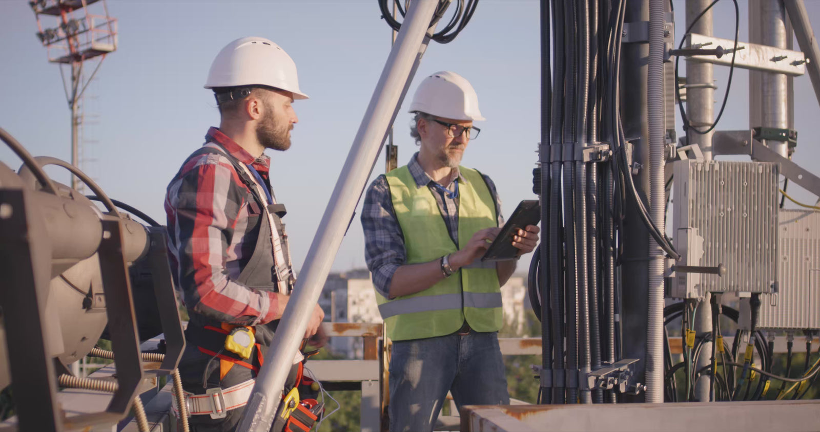 technicians fixing transmitting antenna